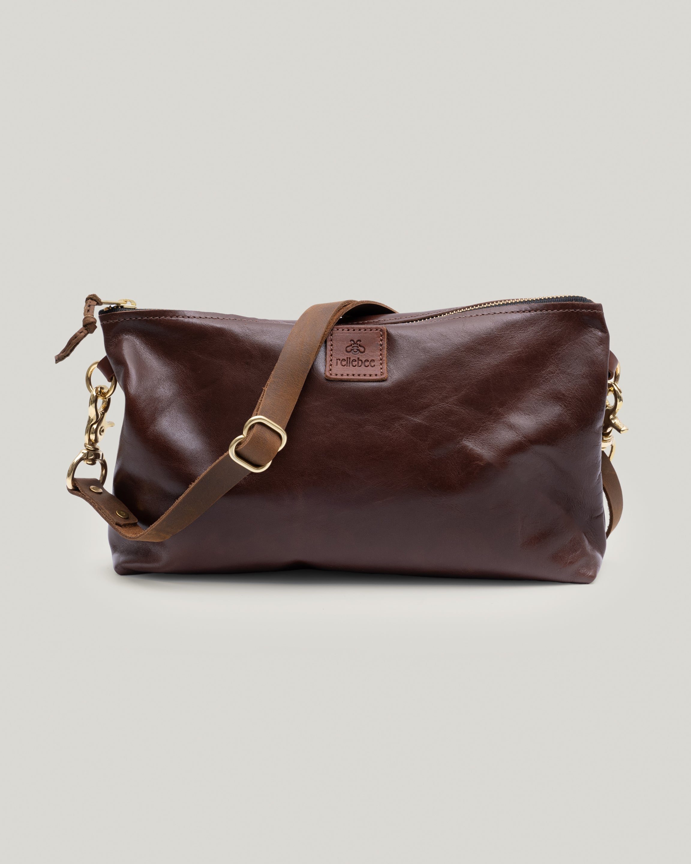 Image of the Brooklyn sling in brown sheen: The Brooklyn is wedge in shape and extremely versatile. Wear it snuggly over your shoulder, tucked under your arm, lengthen the crazy horse leather bridle strap to wear as a cross body or unsnap and carry as a clutch.