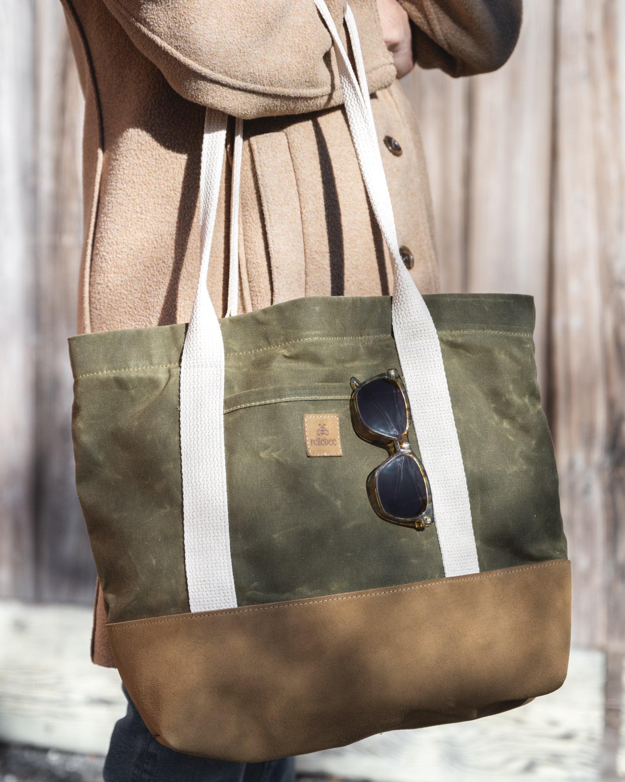 Close up image of model holding the Waxed Rosemary with Tan leather