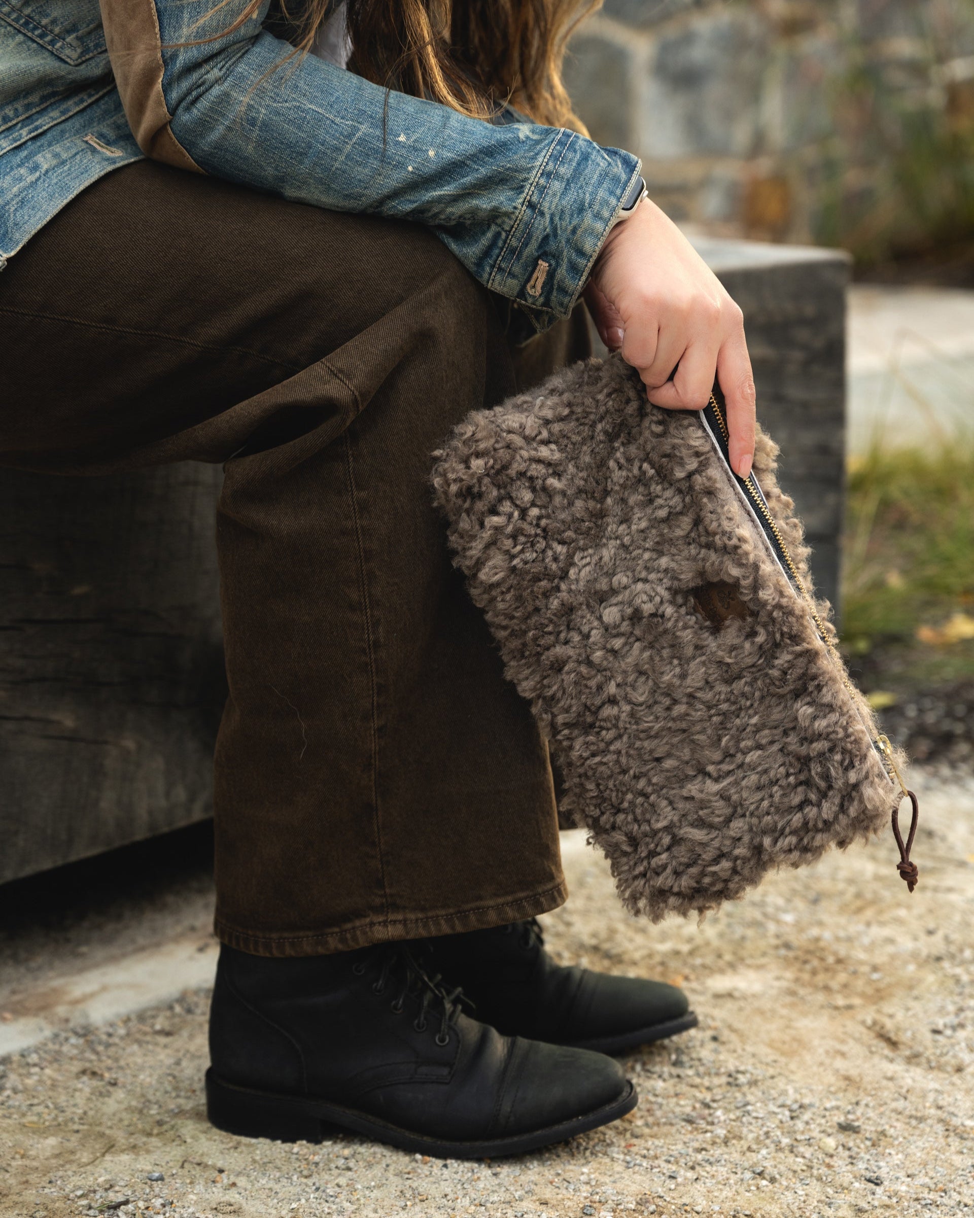 Image of model holding the clutch in shearling