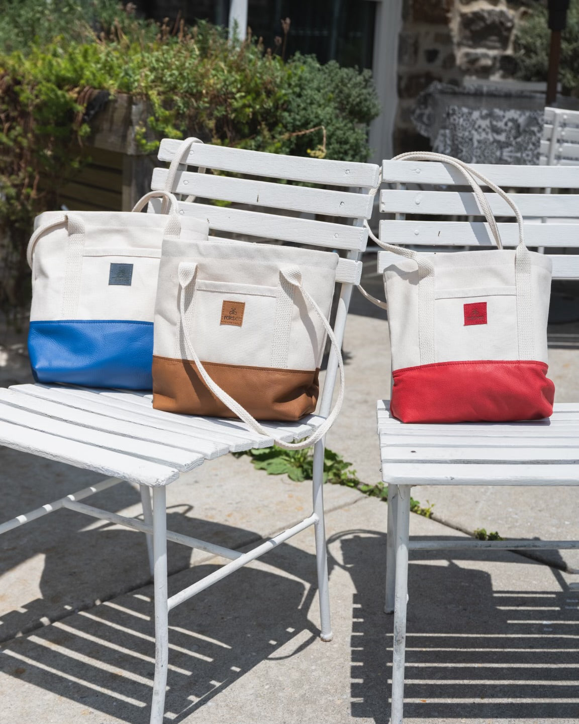 Image of the product Little Everyday Tote in assorted colors. Totes are perched on chairs