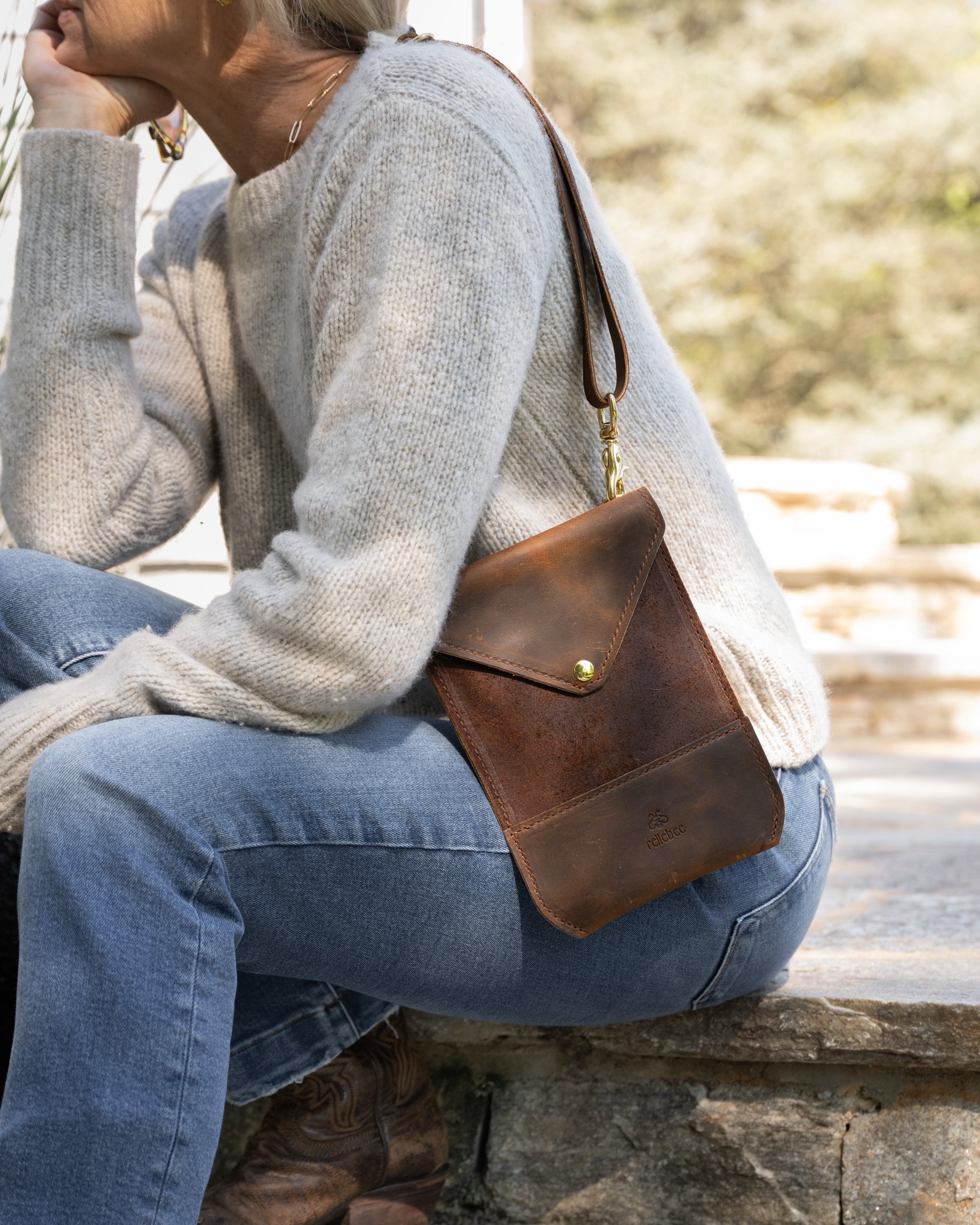 Closeup image of model wearing the Envelope sling