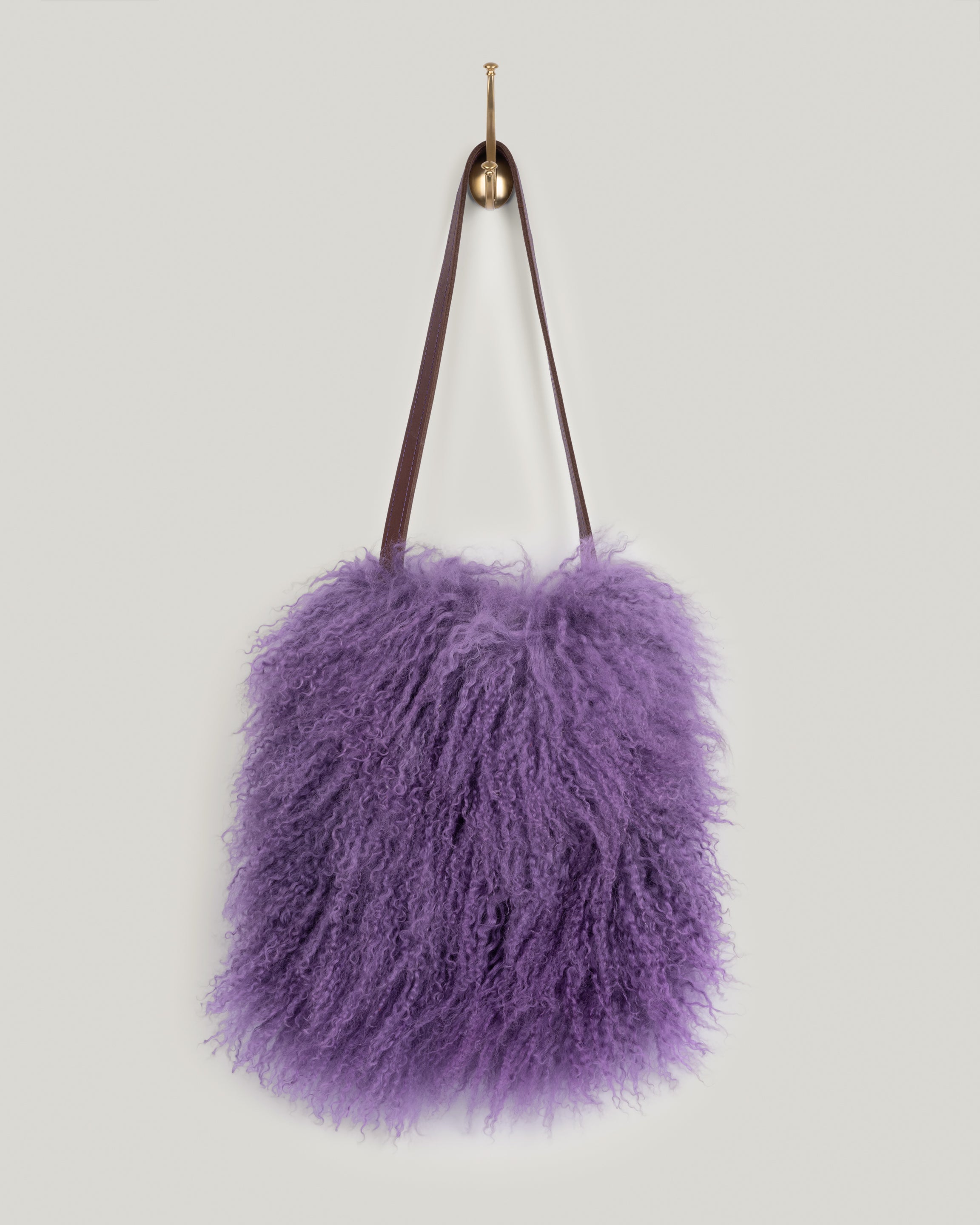 Image of the product Mongolian in Mulberry Haze(lined):The Mongolian is loaded with personality. Simple shape. Single leather strap with topstitching. Just big enough for your phone, water bottle, sunglasses, clutch, wallet and keys. This bag blows in the wind and moves right along with you. You won't want to put it down. Vintage vibe. Lined with an inside pocket.