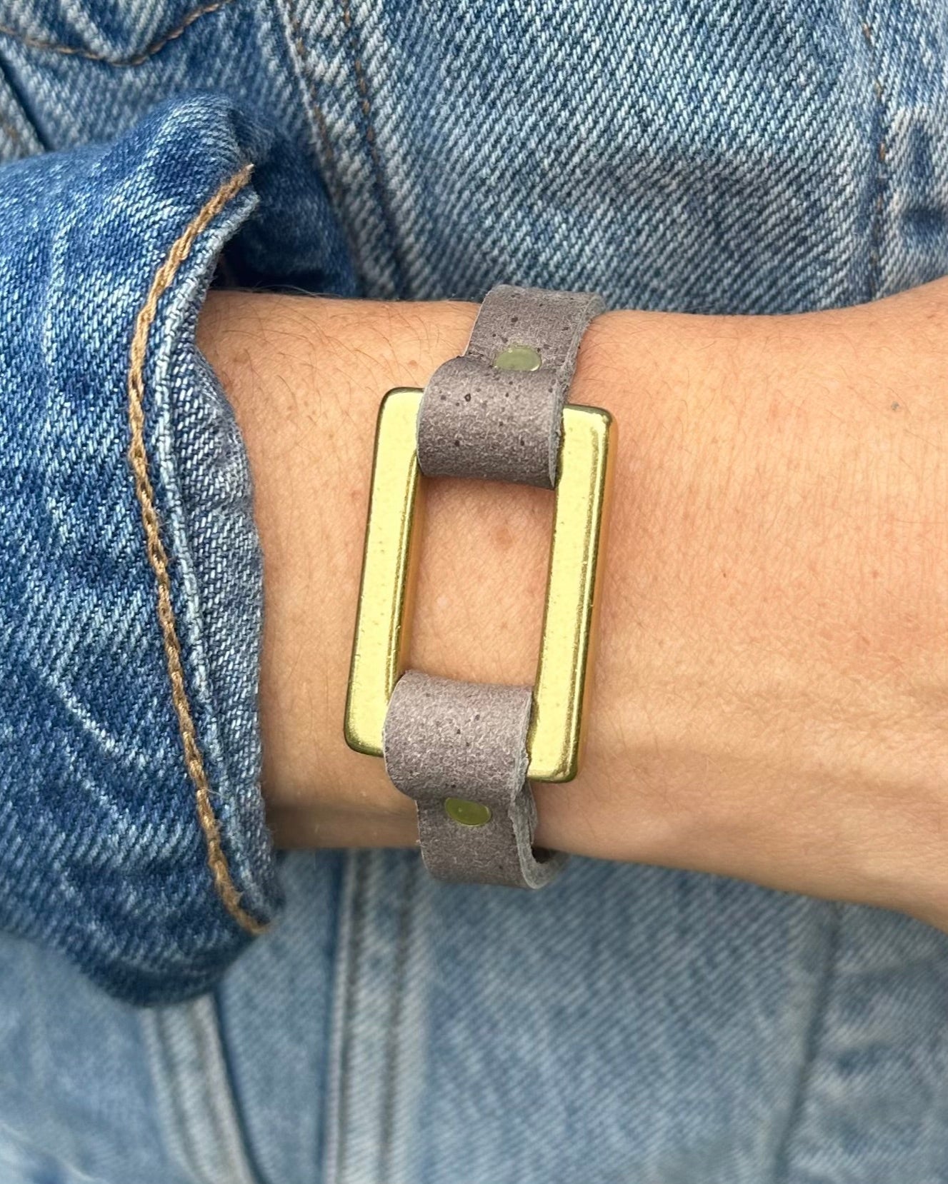 close up Image of model wearing the stirrup strap bracelet in smoke