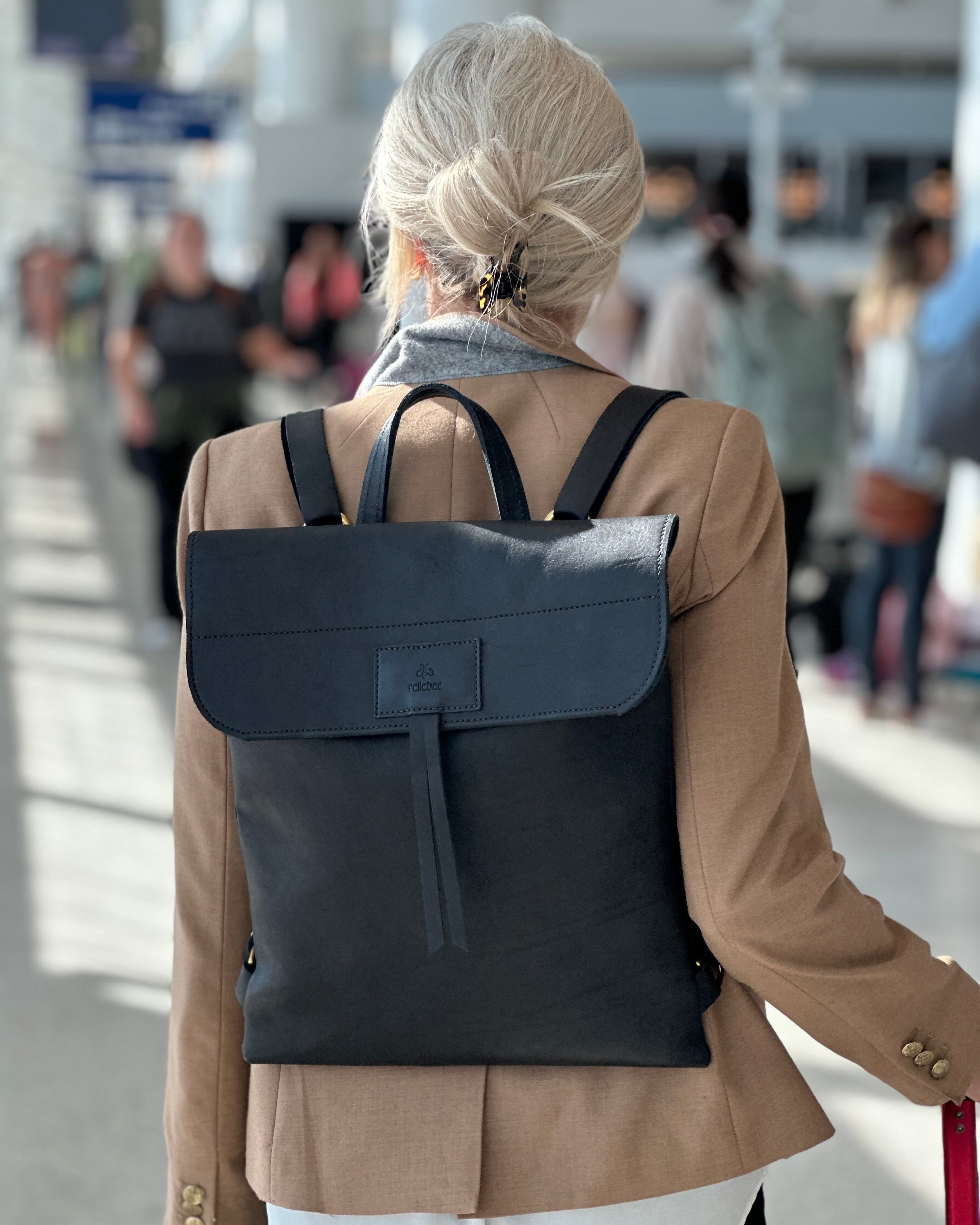 Back view image of model wearing the product Messenger pack in Jet Black