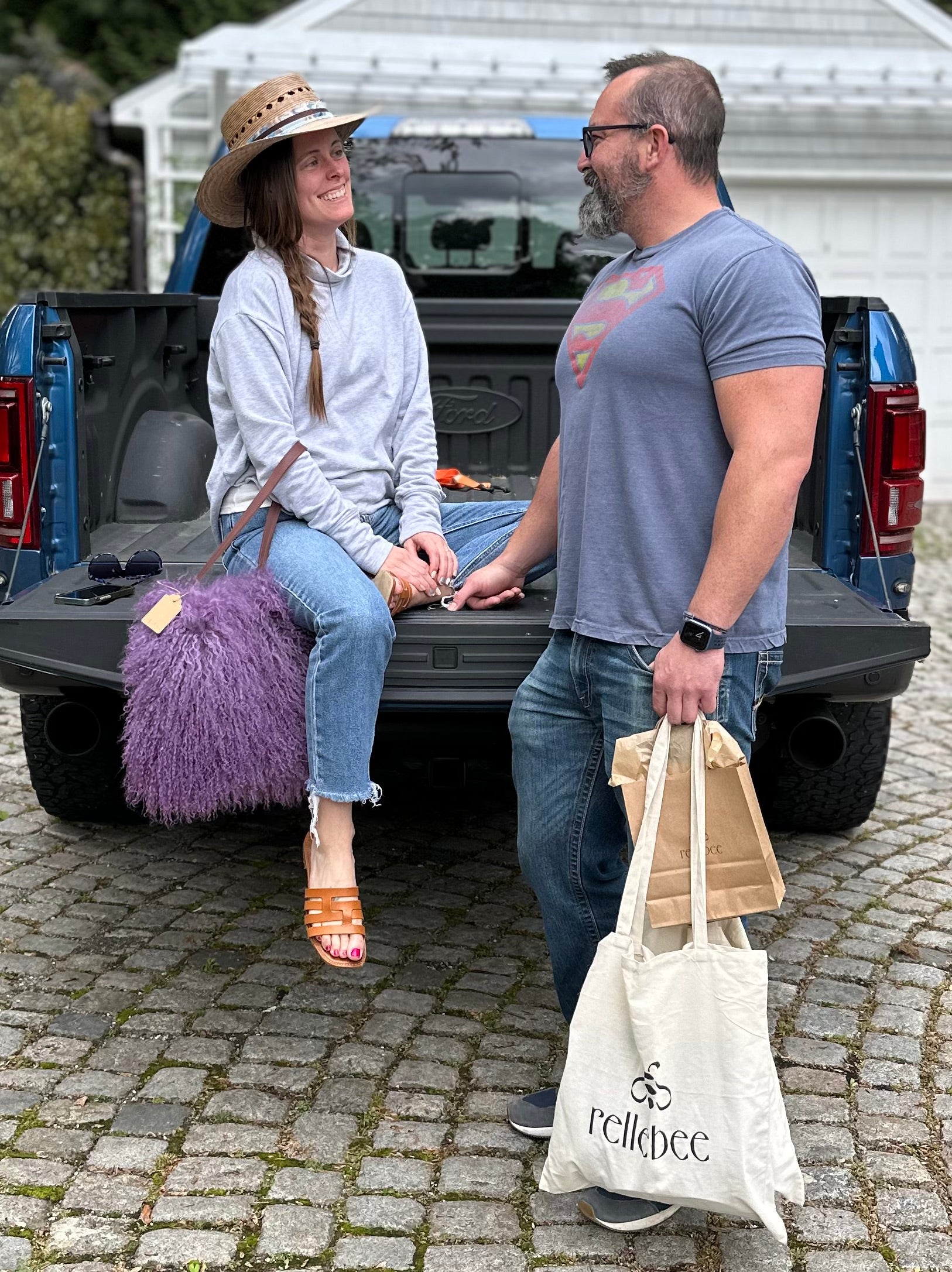 Image of couple with model sitting on a truck flatbed while holding the Mongolian in Mulberry haze