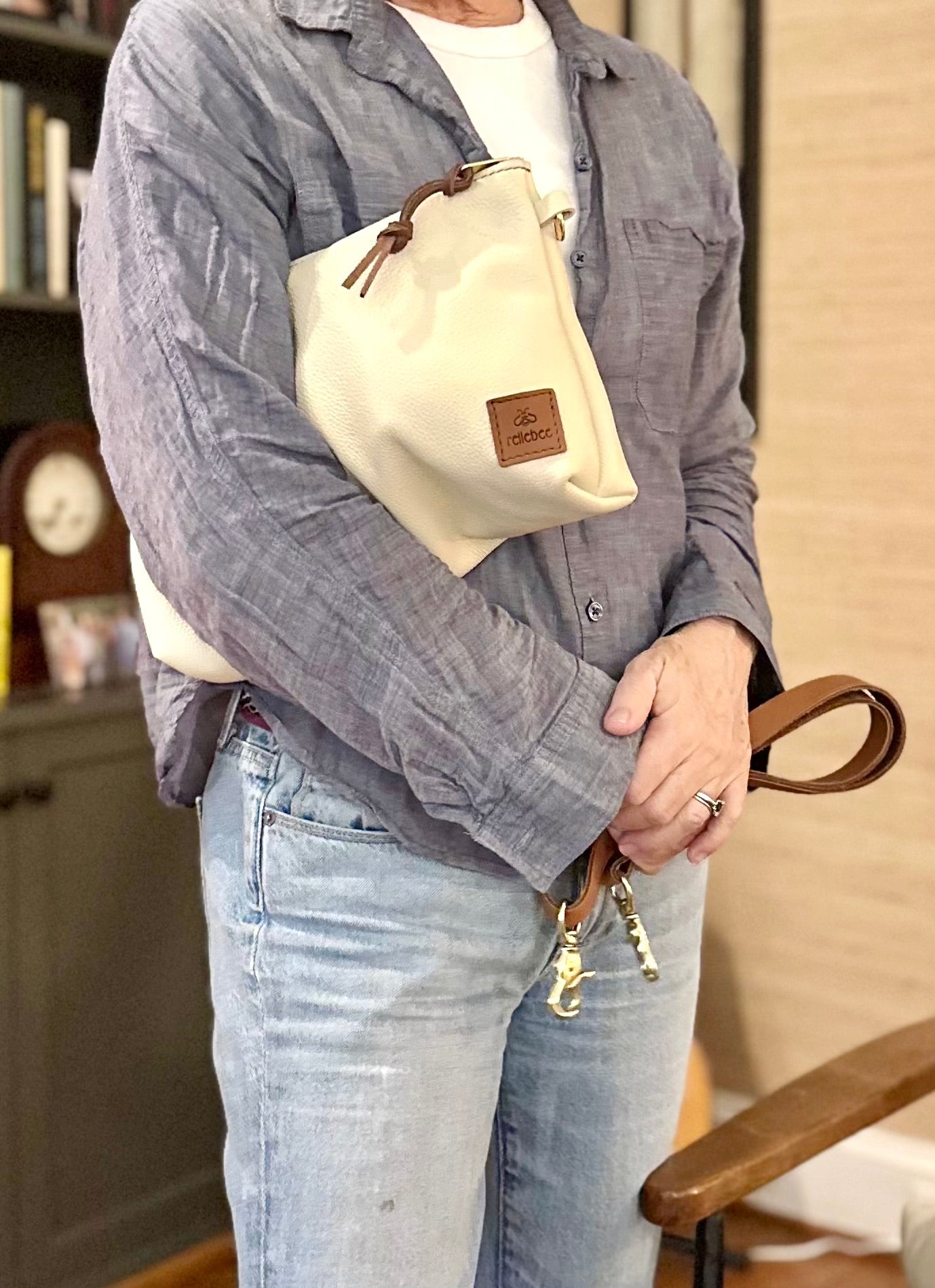 Image of model holding the Brooklyn sling in oat milk