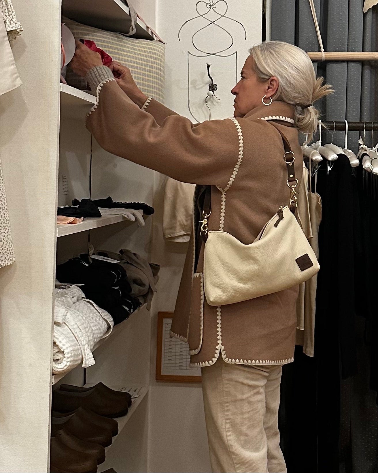 Side view image of Sorrel wearing the Brooklyn sling in oat milk