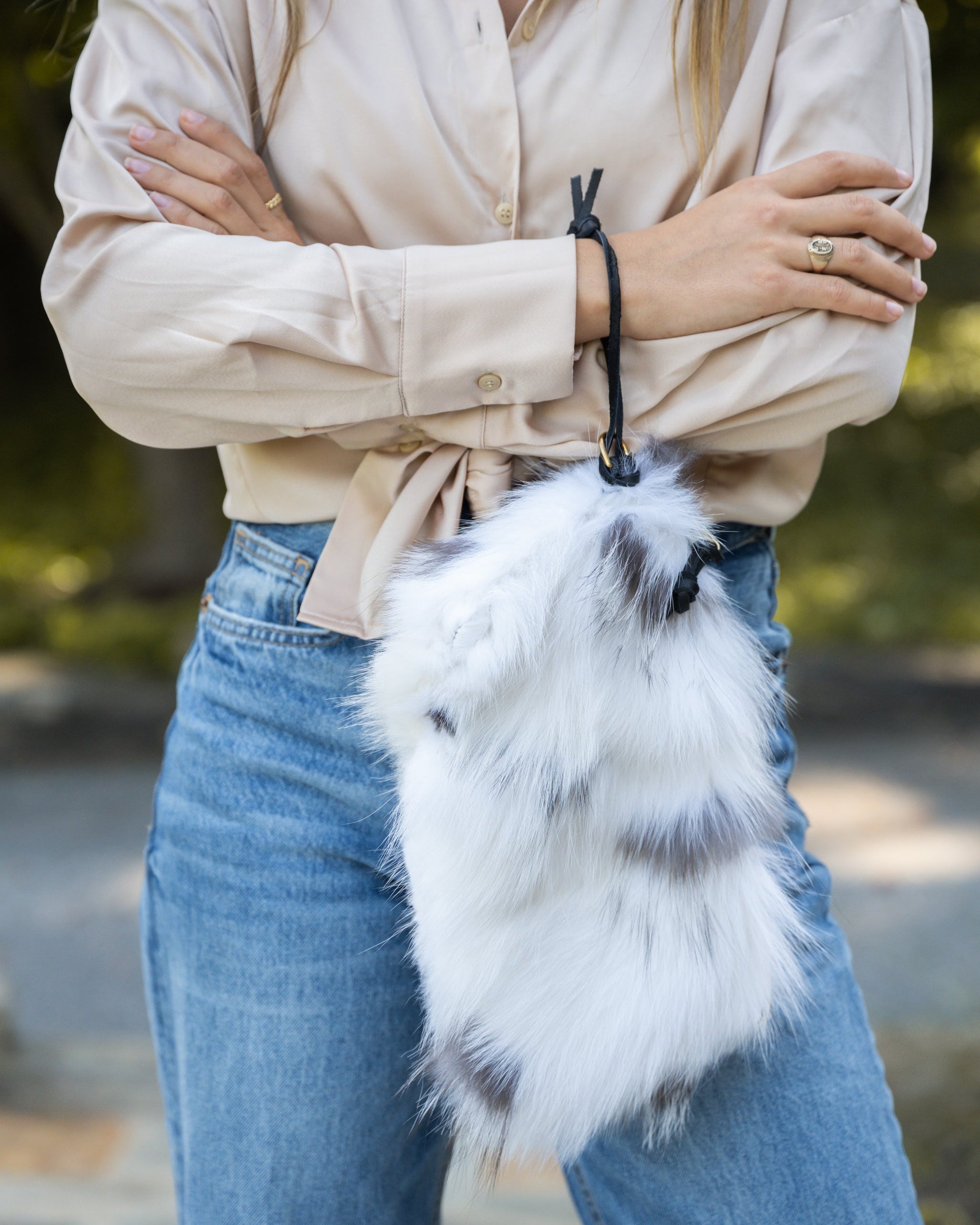 Image of model using the wristlet to hold the clutch in arctic