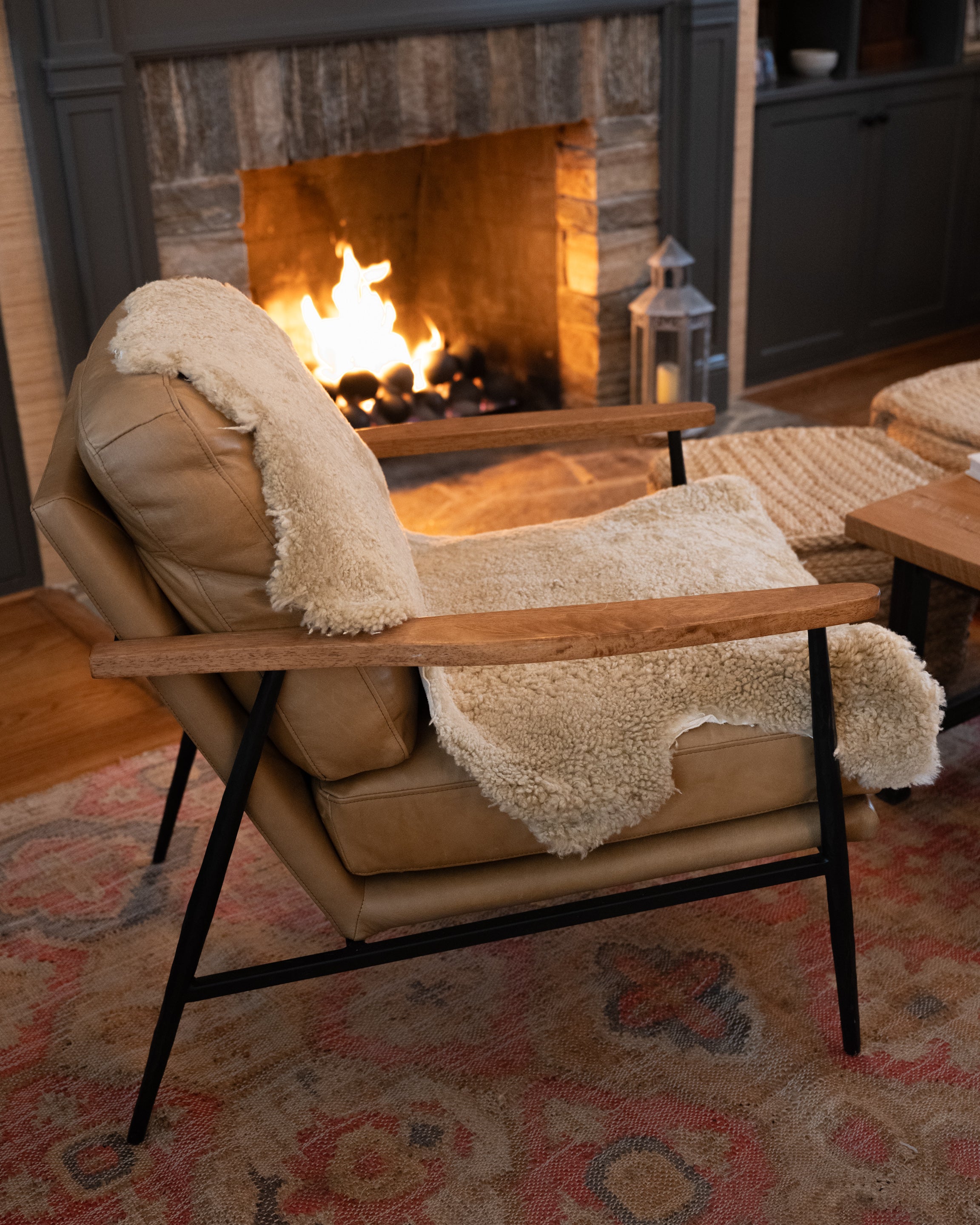 Image of product New Zealand Sheepskin in Natural color on a chair: Each hide is unique with its own variations and texture that make these natural products so special. Their rustic and authentic feel will add warmth to any room. Drape one over a chair. Lay one down in front of your hearth. Perfect cozy spot for man's best friend. Ethically sourced.
