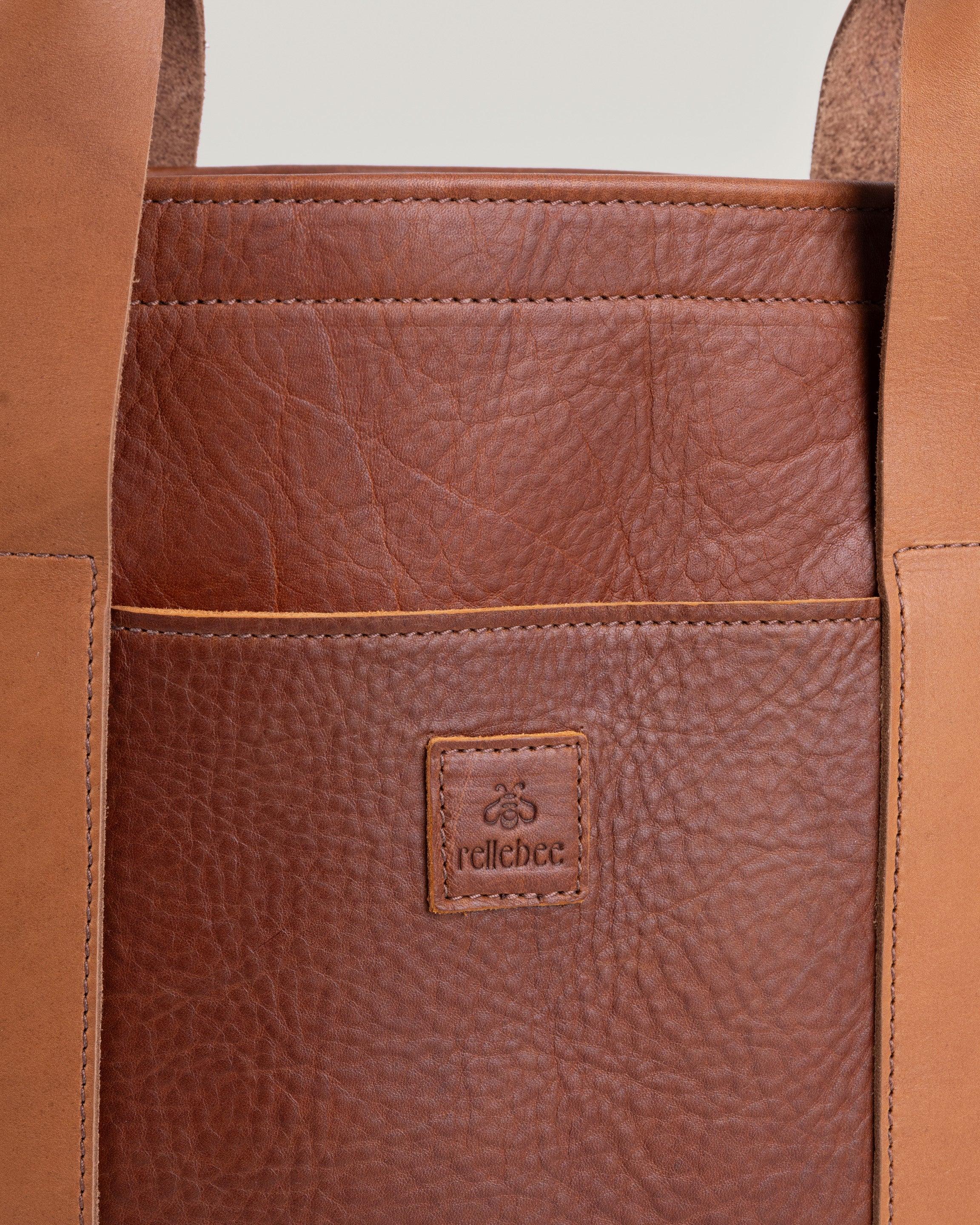 Close-up of saddle brown full-grain leather texture on the Berkshire tote bag