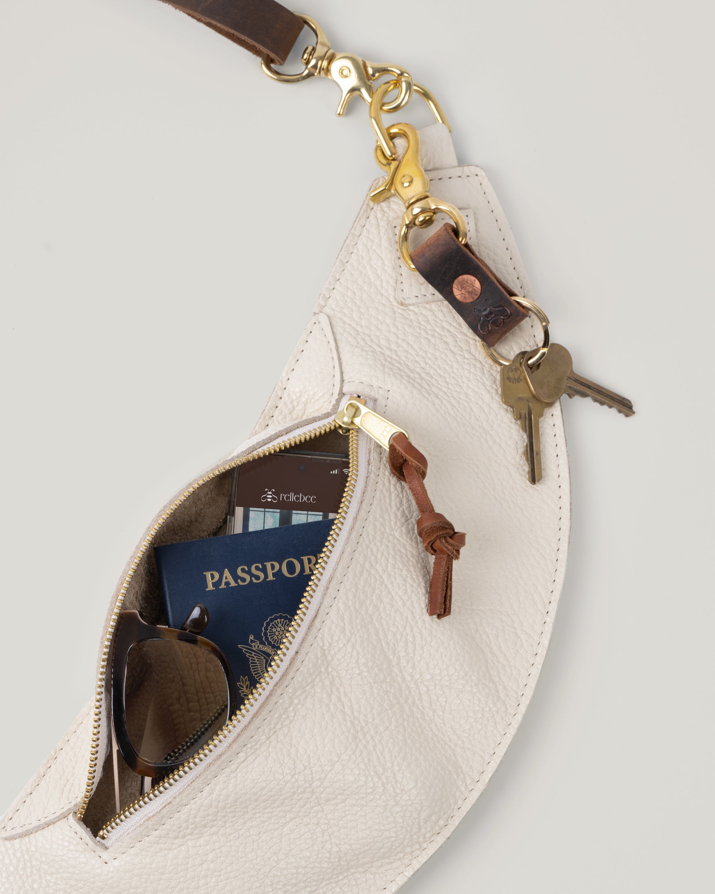 Image of product Classic sling in oat milk with the zipper open showing inside