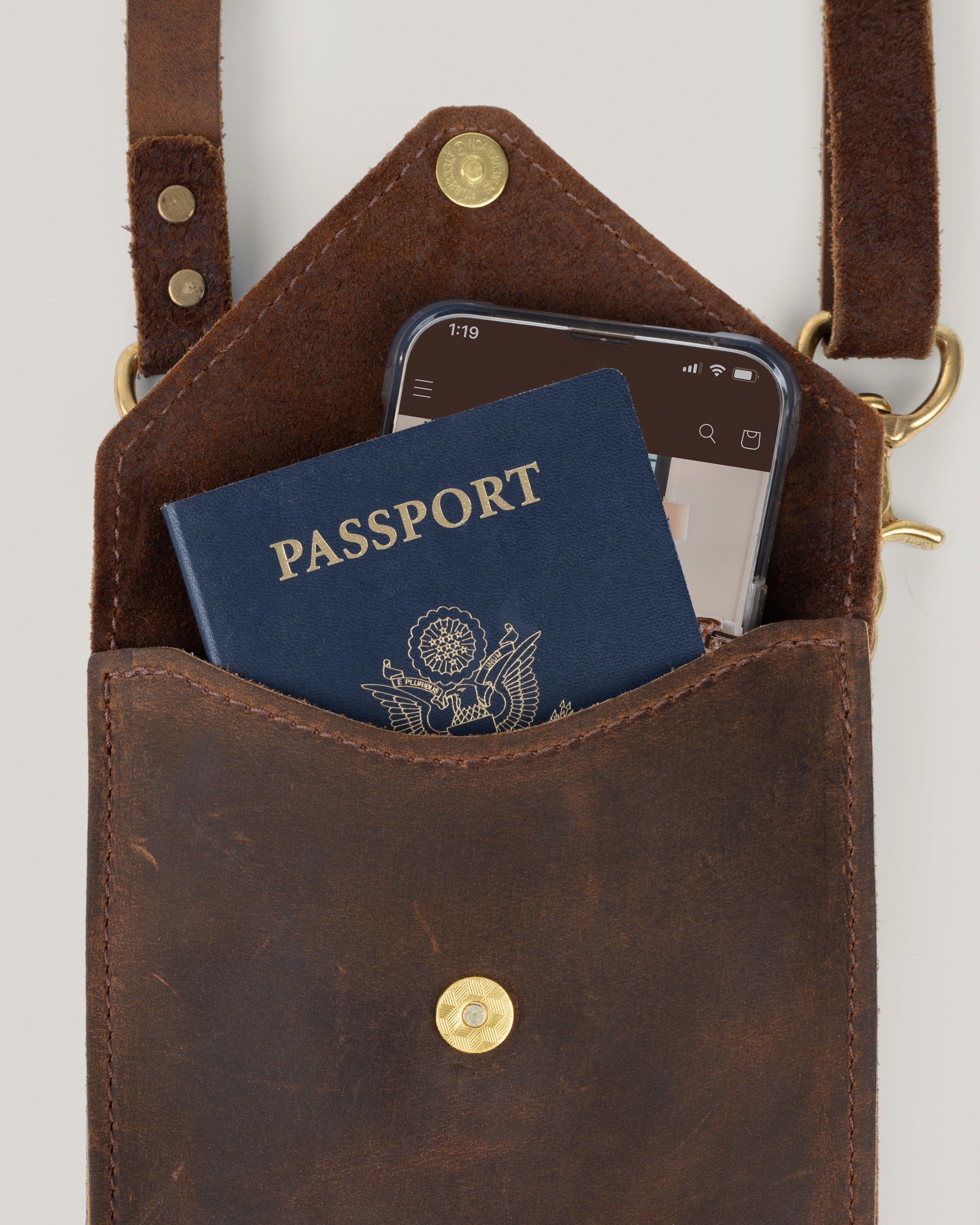 Closeup image of the Envelope sling with the flap open filled with items
