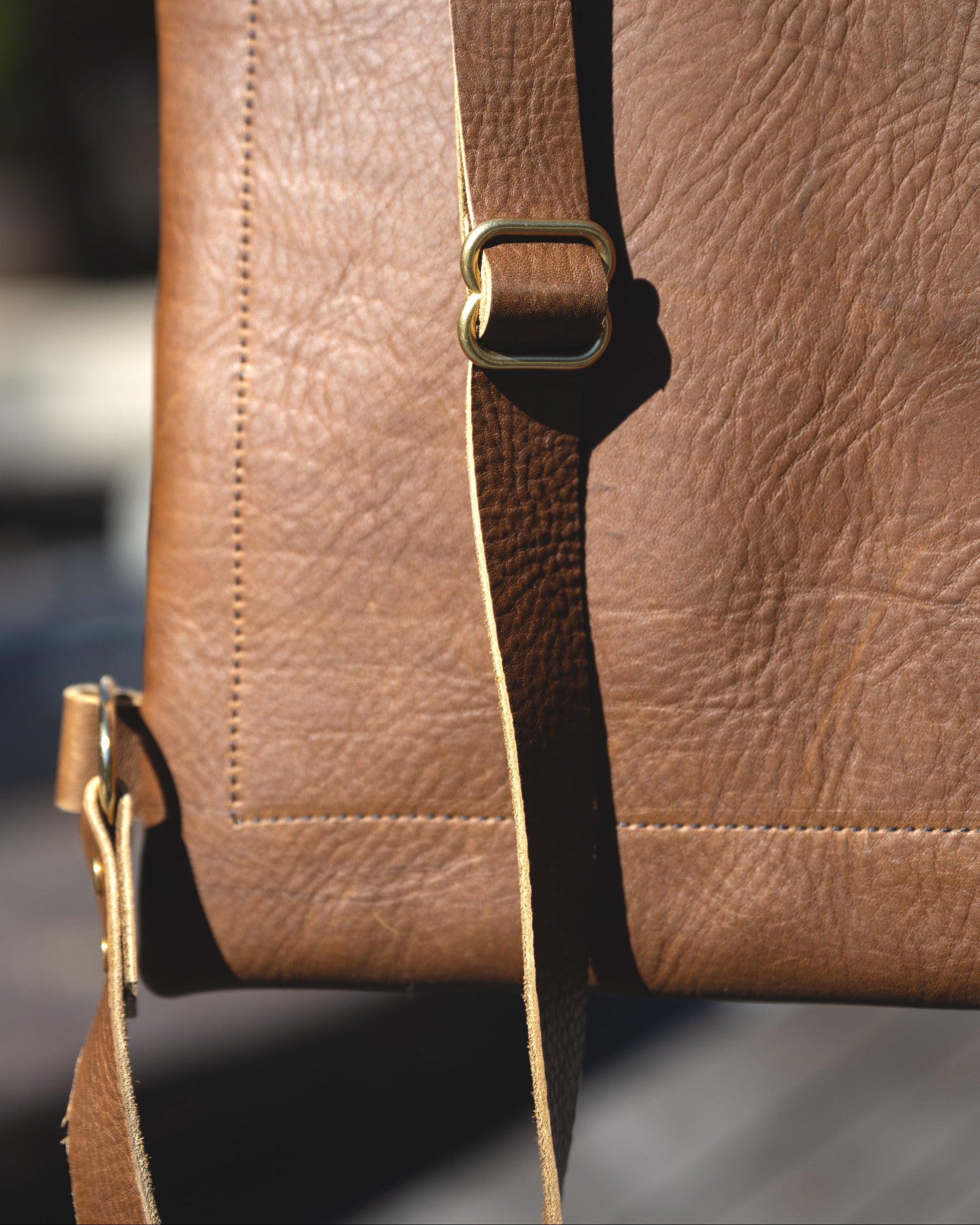 Closeup view of the Messenger pack in olive brown. Showing the straps