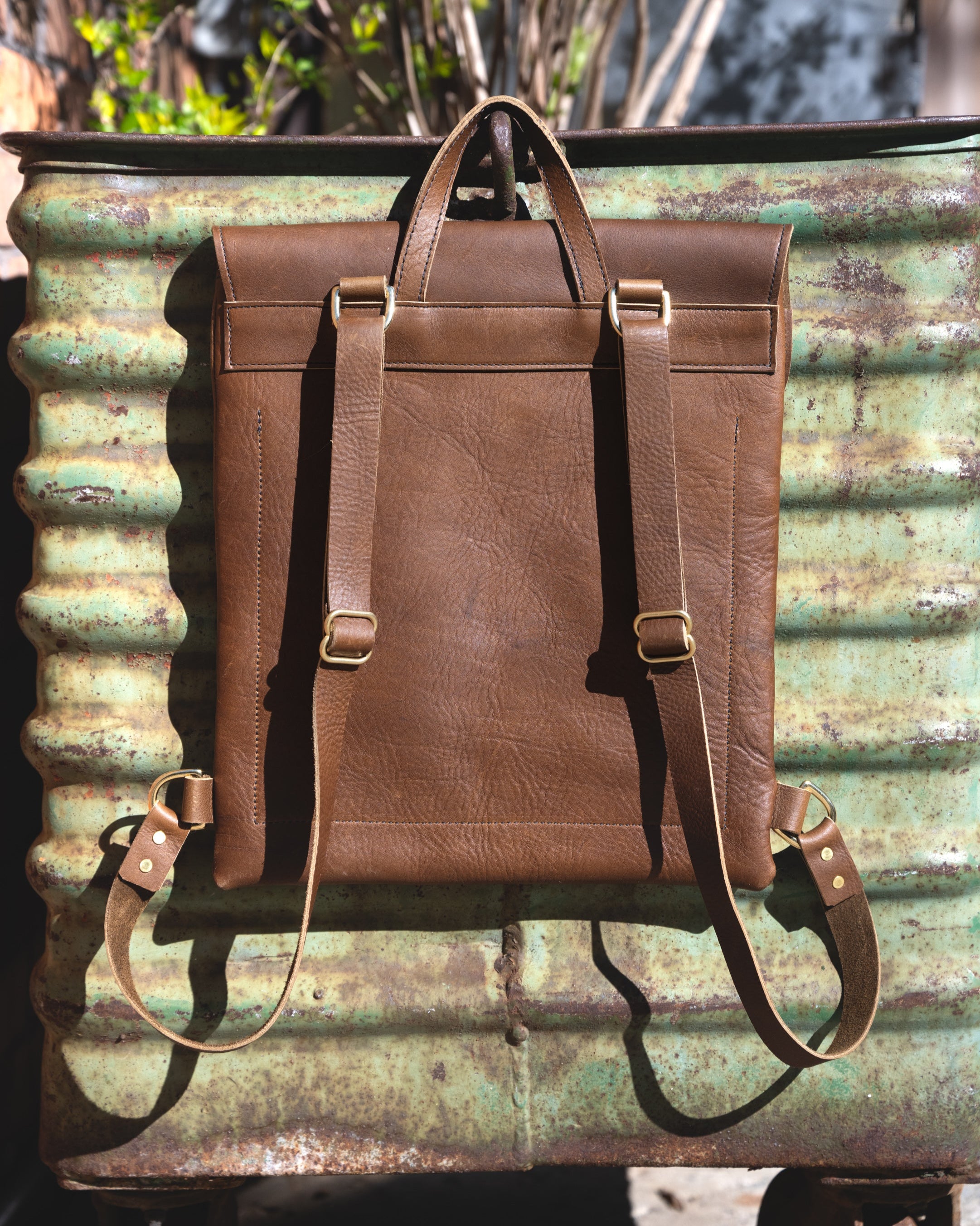 Back side view of the Messenger pack in Olive brown.