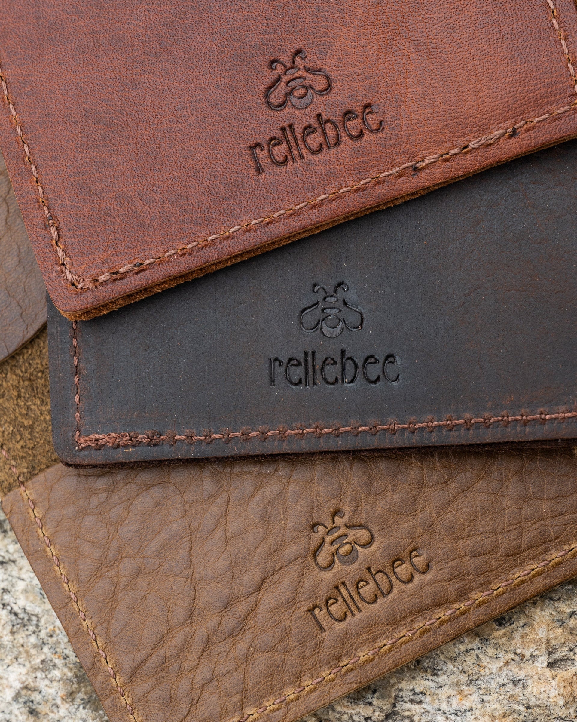 Close up view of the minimalist wallet in assorted colours showing the rellebee logo