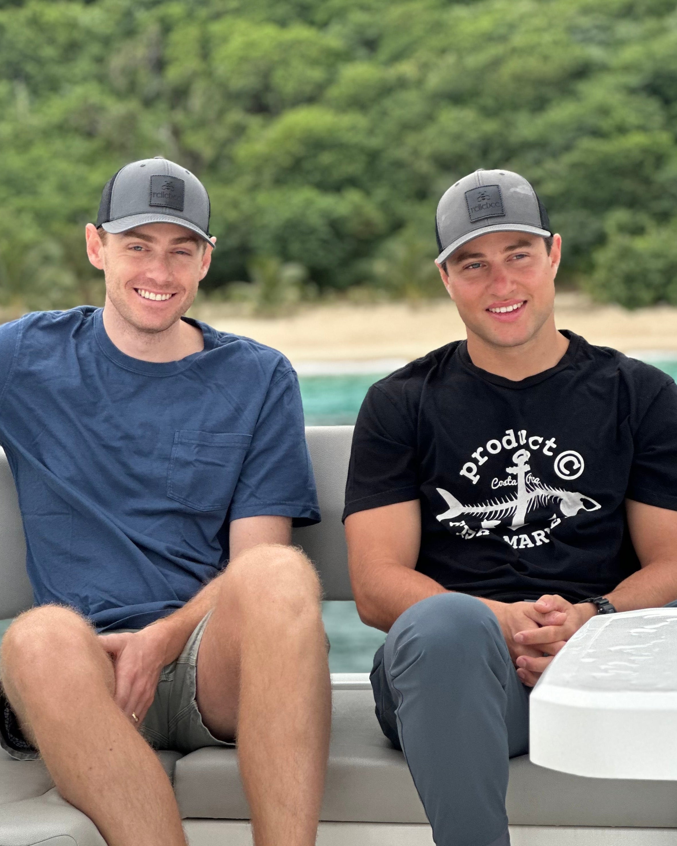 Image of two models sitting down and wearing the Cap. 