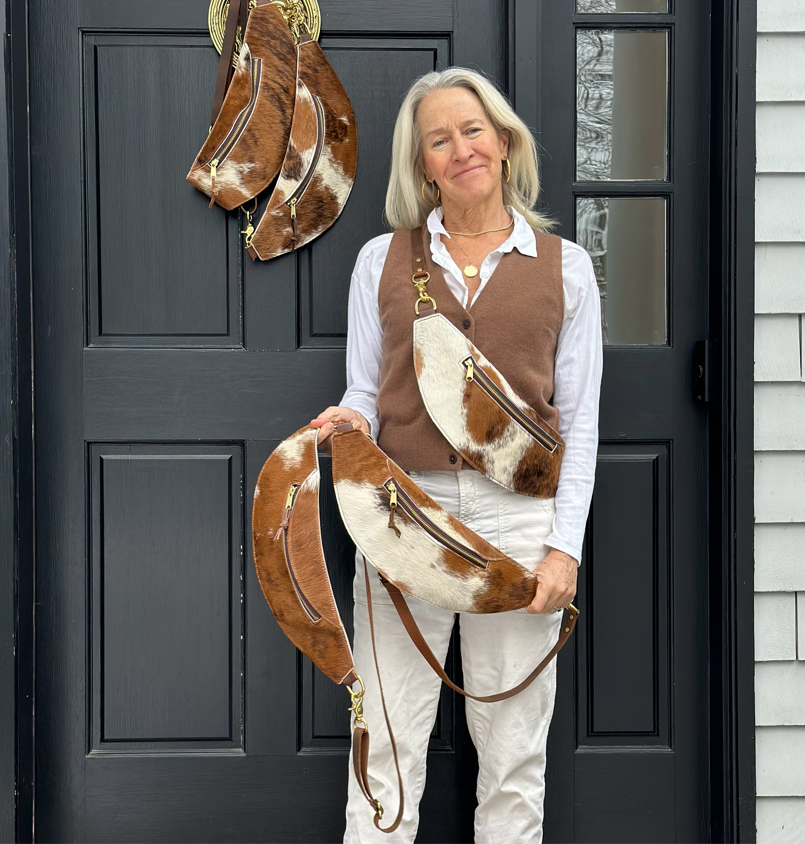 Image of Sorrel holding the classic sling:Hair-on-hide in brindle. 