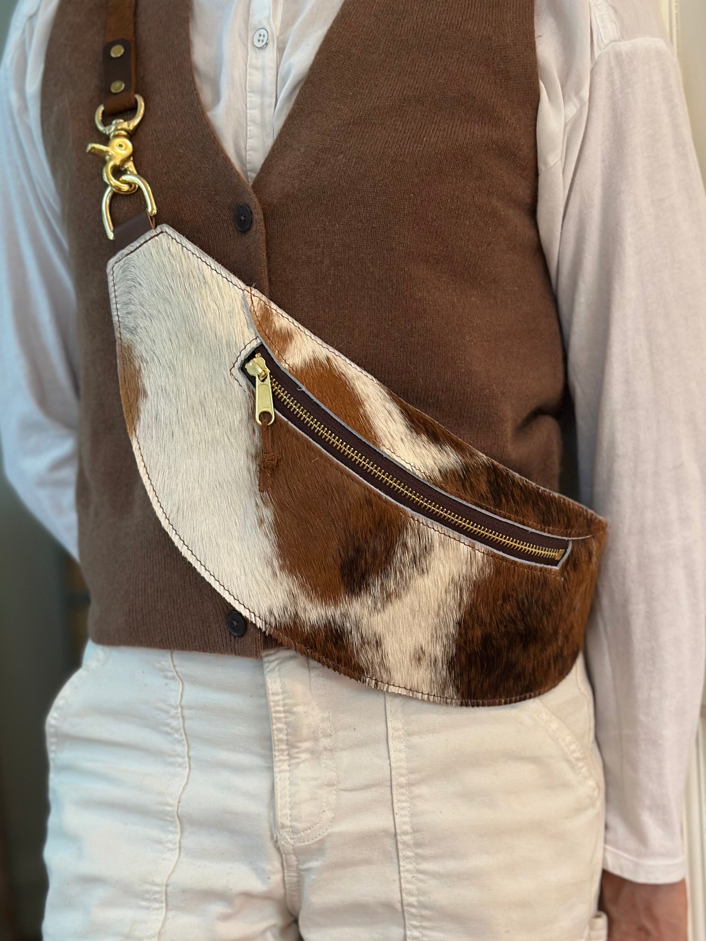 Closeup view of model wearing the classic sling:Hair-on-hide in brindle. 