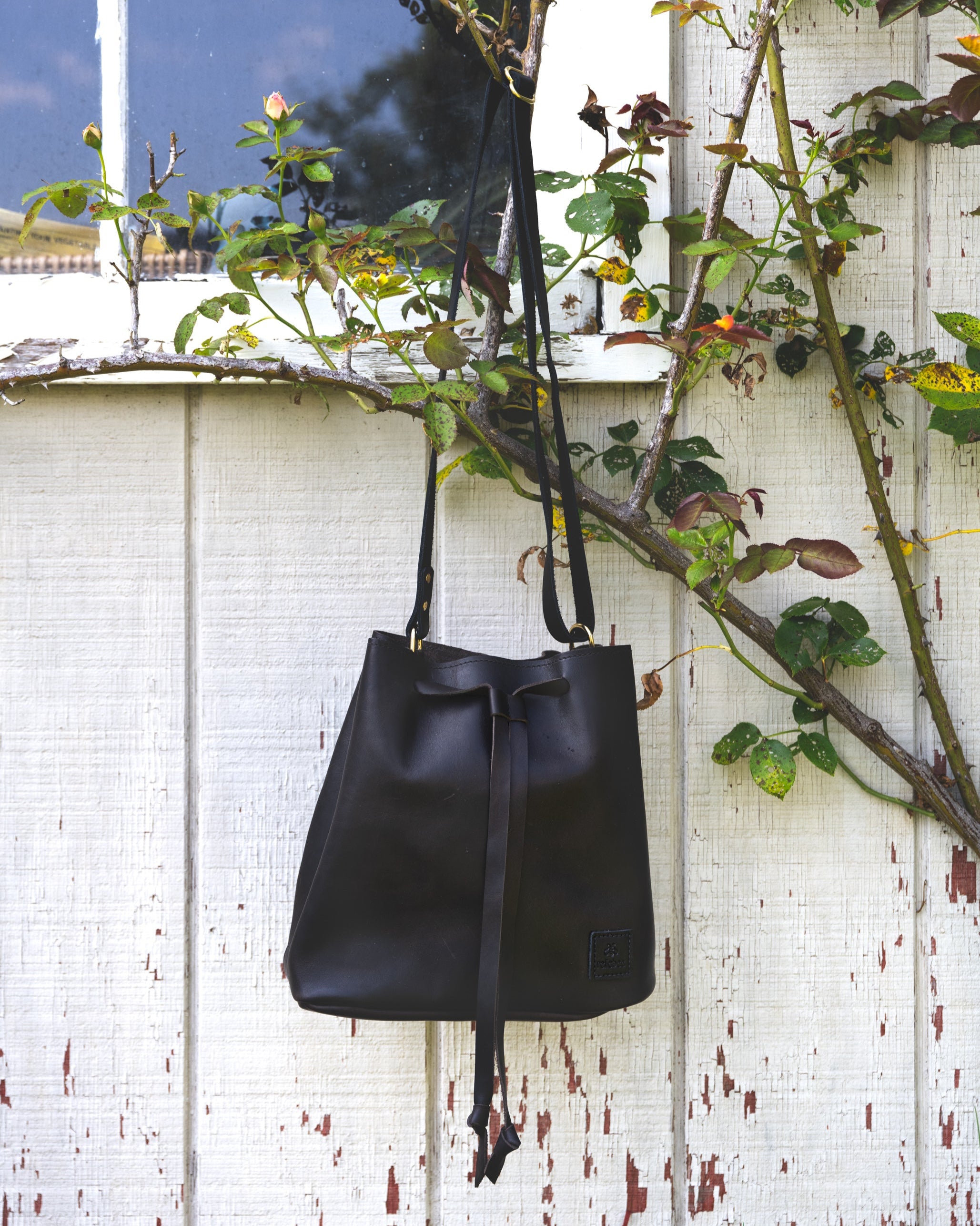 Image of the Bucket Bag hanging on a tree 