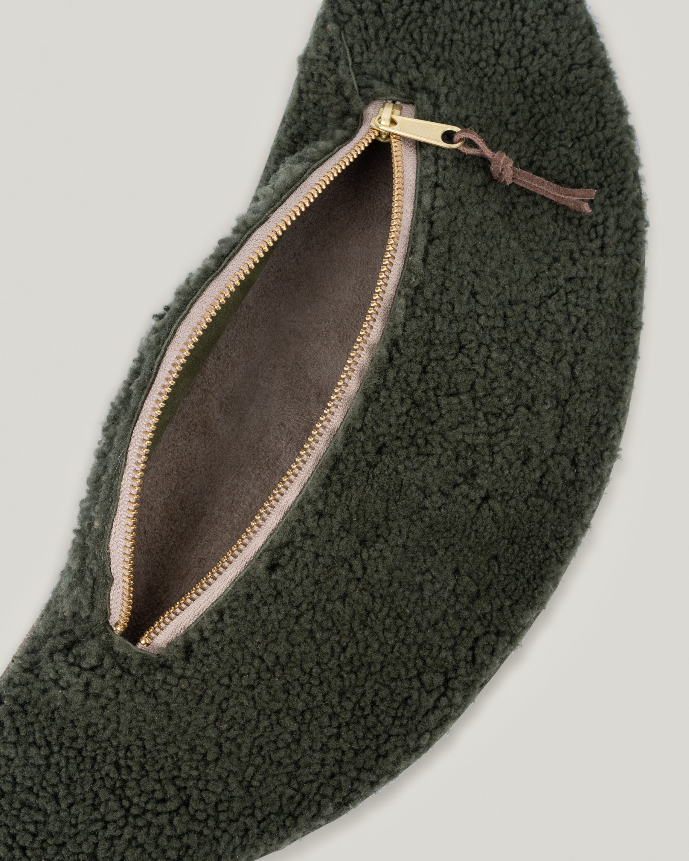 Closeup view of the Classic sling: shearling in Spruce. Showing the interior of the sling