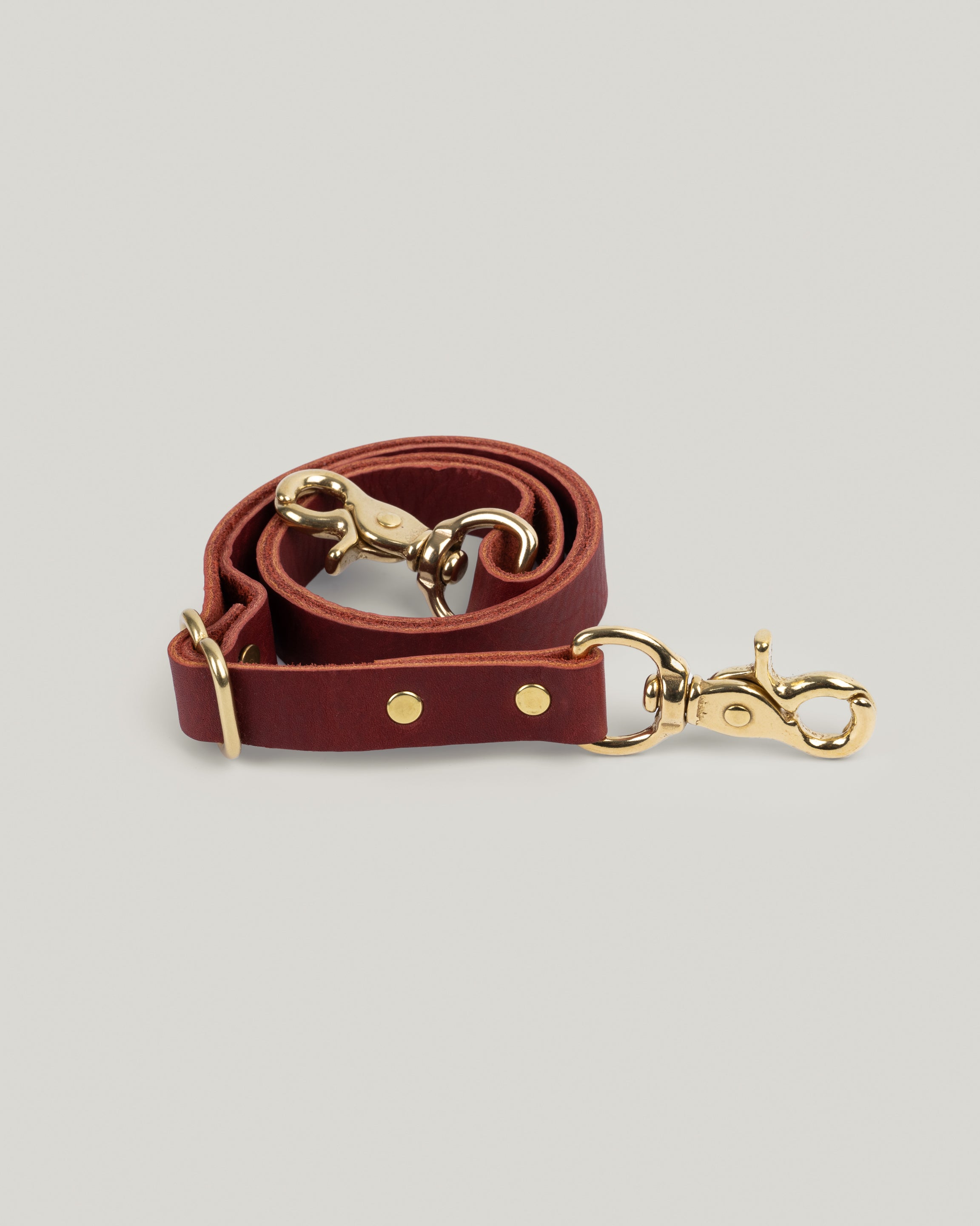 Image of the product Leather Bridle straps in Merlot: Five ounce full-grain leather sourced from a tannery in Wisconsin. We use the highest quality brass swivel hooks and sliders to give these straps an elevated look and feel. Adjustable from 19 inches to 38 inches gives you the option to wear your favorite bag as a cross body or over your shoulder.