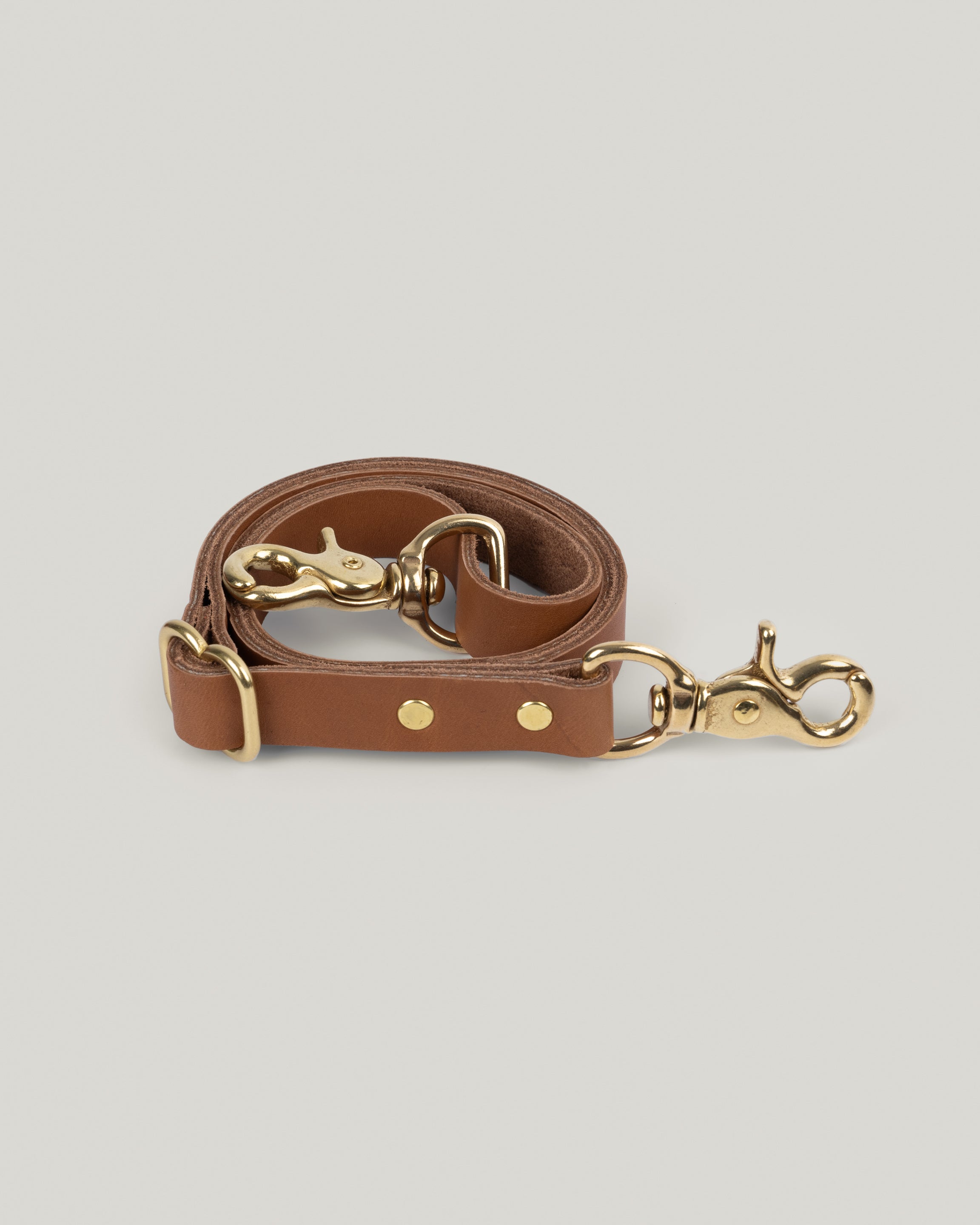 Image of the product Leather Bridle straps in Honey: Five ounce full-grain leather sourced from a tannery in Wisconsin. We use the highest quality brass swivel hooks and sliders to give these straps an elevated look and feel. Adjustable from 19 inches to 38 inches gives you the option to wear your favorite bag as a cross body or over your shoulder.