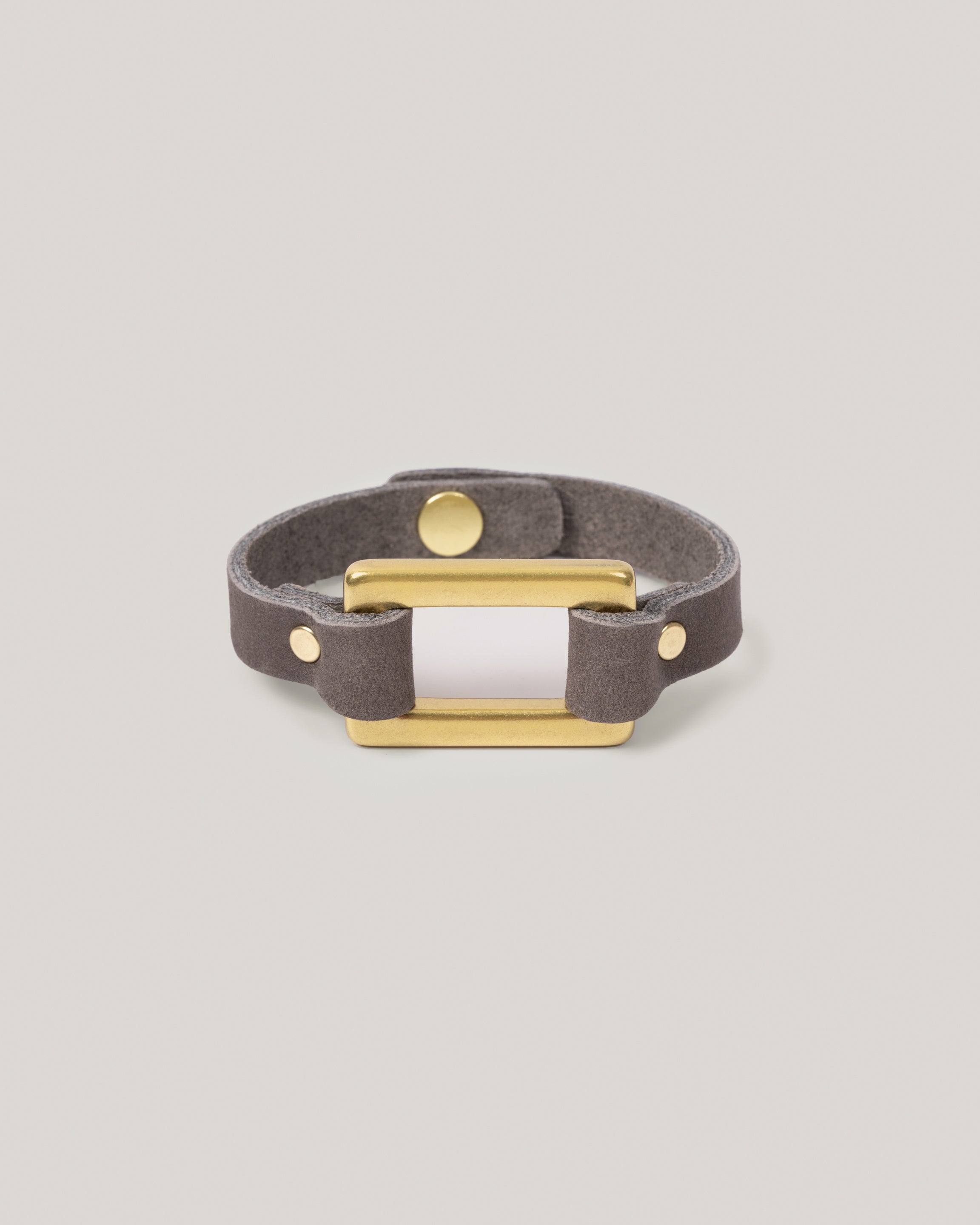 Image of the Stirrup bracelet in smoke: Made from sturdy 5 ounce full grain leather. A nod to the horse country. Dress it up. Dress it down. Looks great layered. Pretty polished brass rectangle ring adds a touch of sophistication. Made by our leather craftsmen friends in Wyoming.&nbsp;
