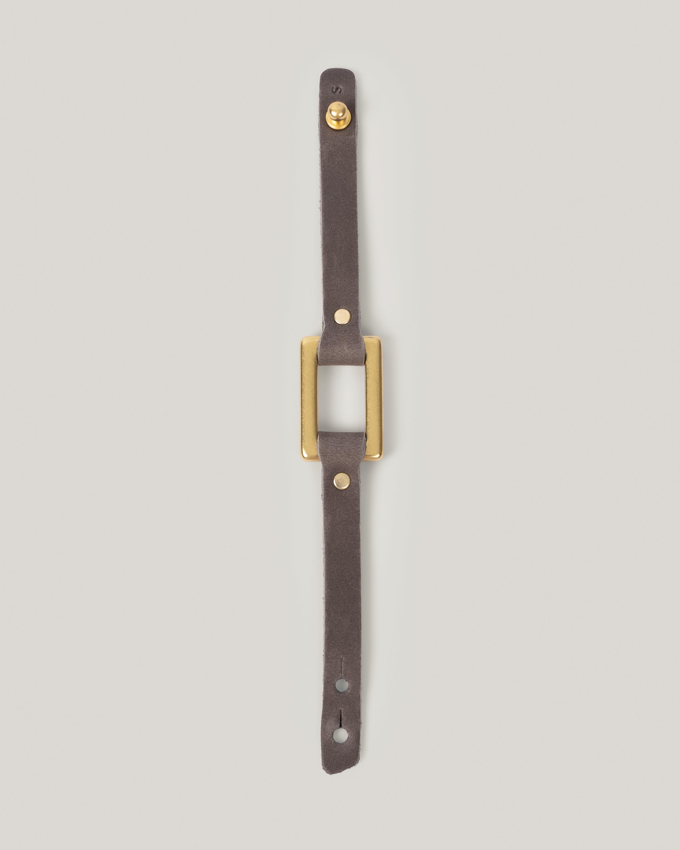Image of the stirrup strap bracelet in smoke fully laid out 